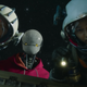 Two astronauts and a robot do a space walk in Space Sweepers.